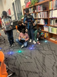 Students enjoying coding with Spheros.